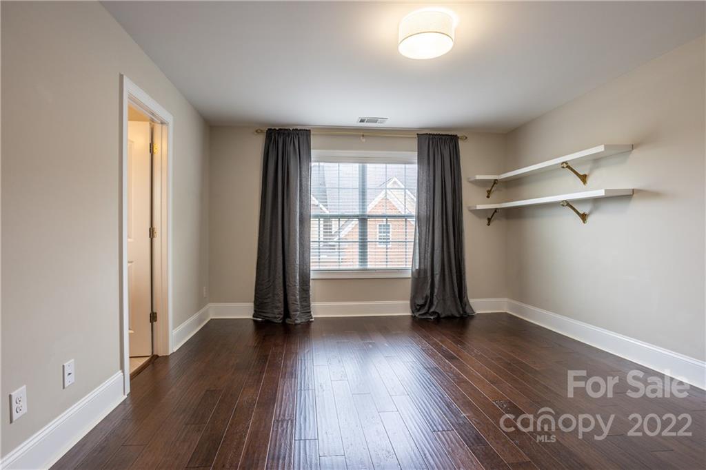 907 Ospre Lane Fort Mill, SC 29708 - Photo 21 of 39 an empty room with wooden floor and windows