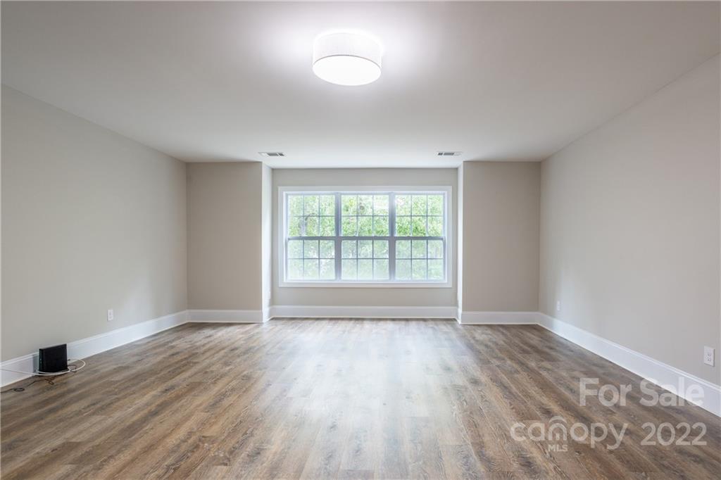 907 Ospre Lane Fort Mill, SC 29708 - Photo 27 of 39 an empty room with wooden floor and windows