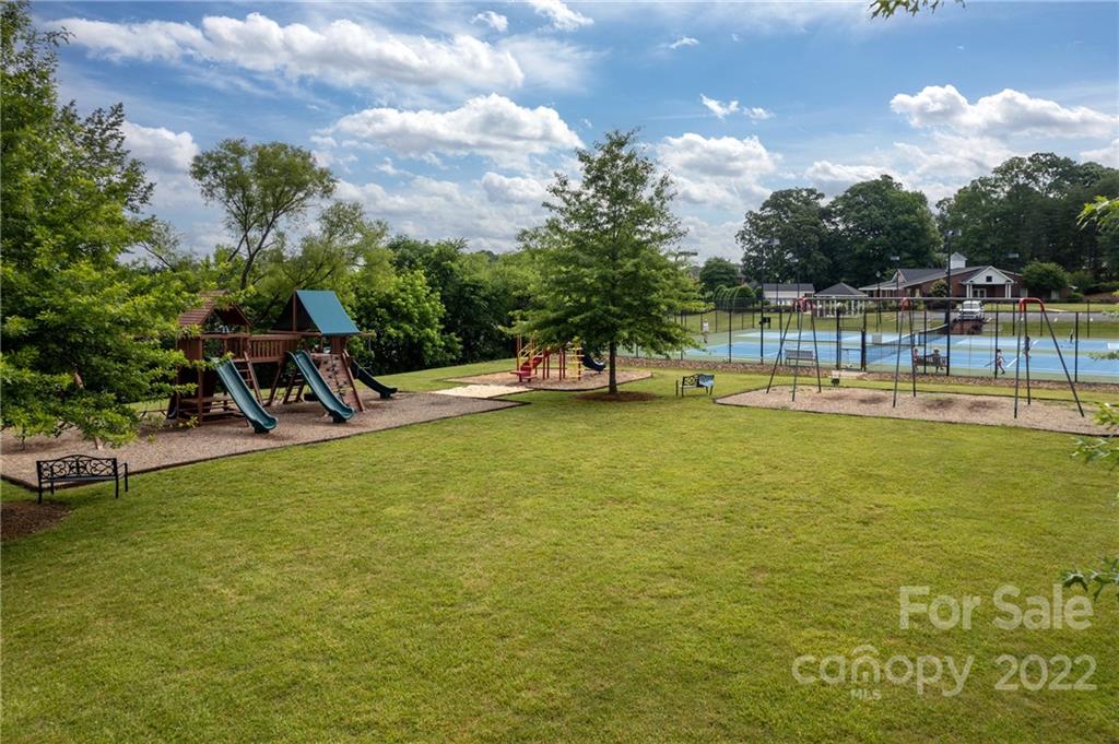 907 Ospre Lane Fort Mill, SC 29708 - Photo 37 of 39 a view of a swimming pool with a bench and trees