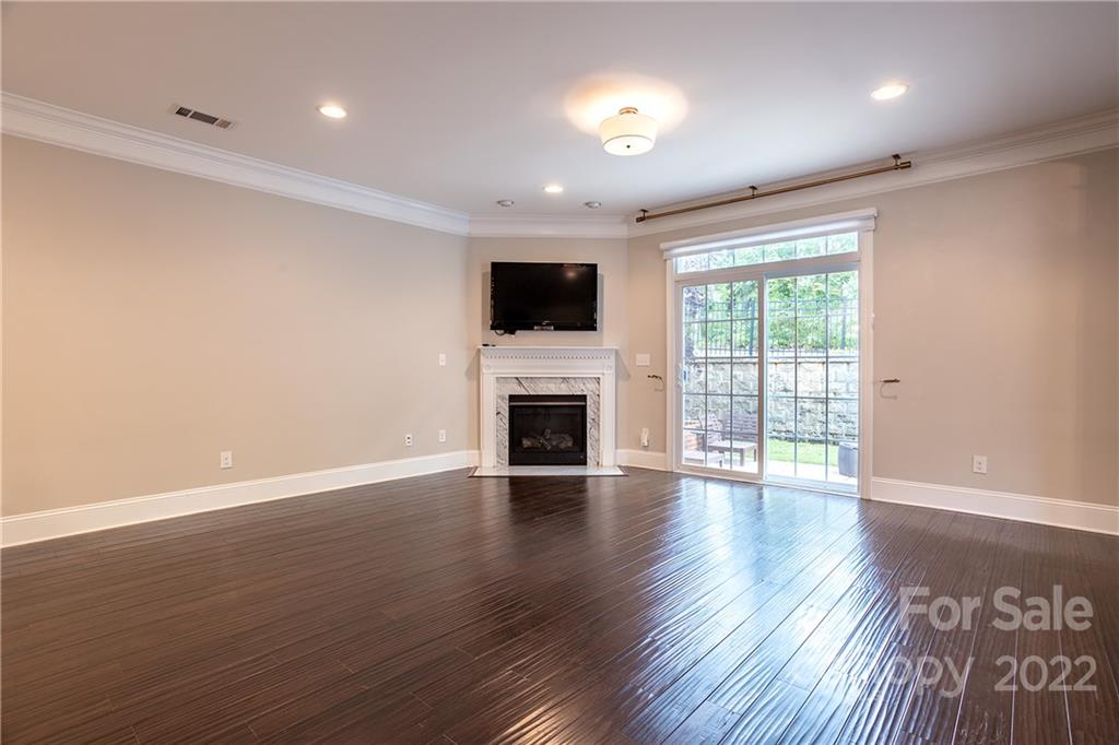 907 Ospre Lane Fort Mill, SC 29708 - Photo 5 of 39 a view of a livingroom with wooden floor and a fireplace