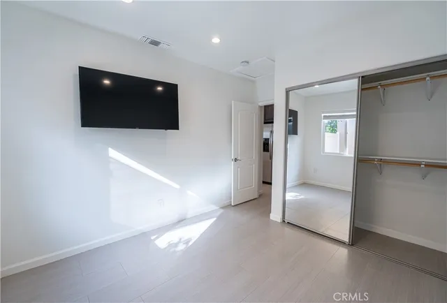 a view of a livingroom with an empty space and a hallway