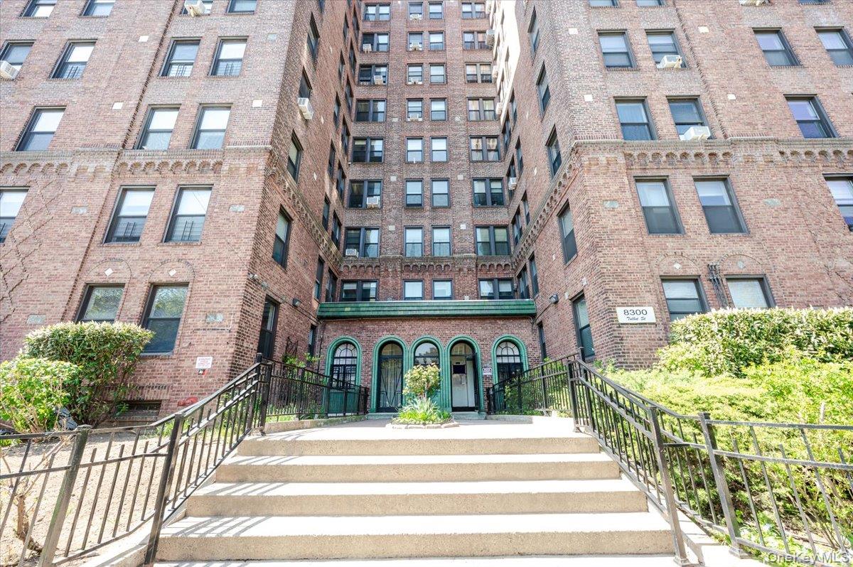 83-00 Talbot Street, Unit 2B Queens, NY 11415 - Photo 1 of 16 a view of a building with a yard