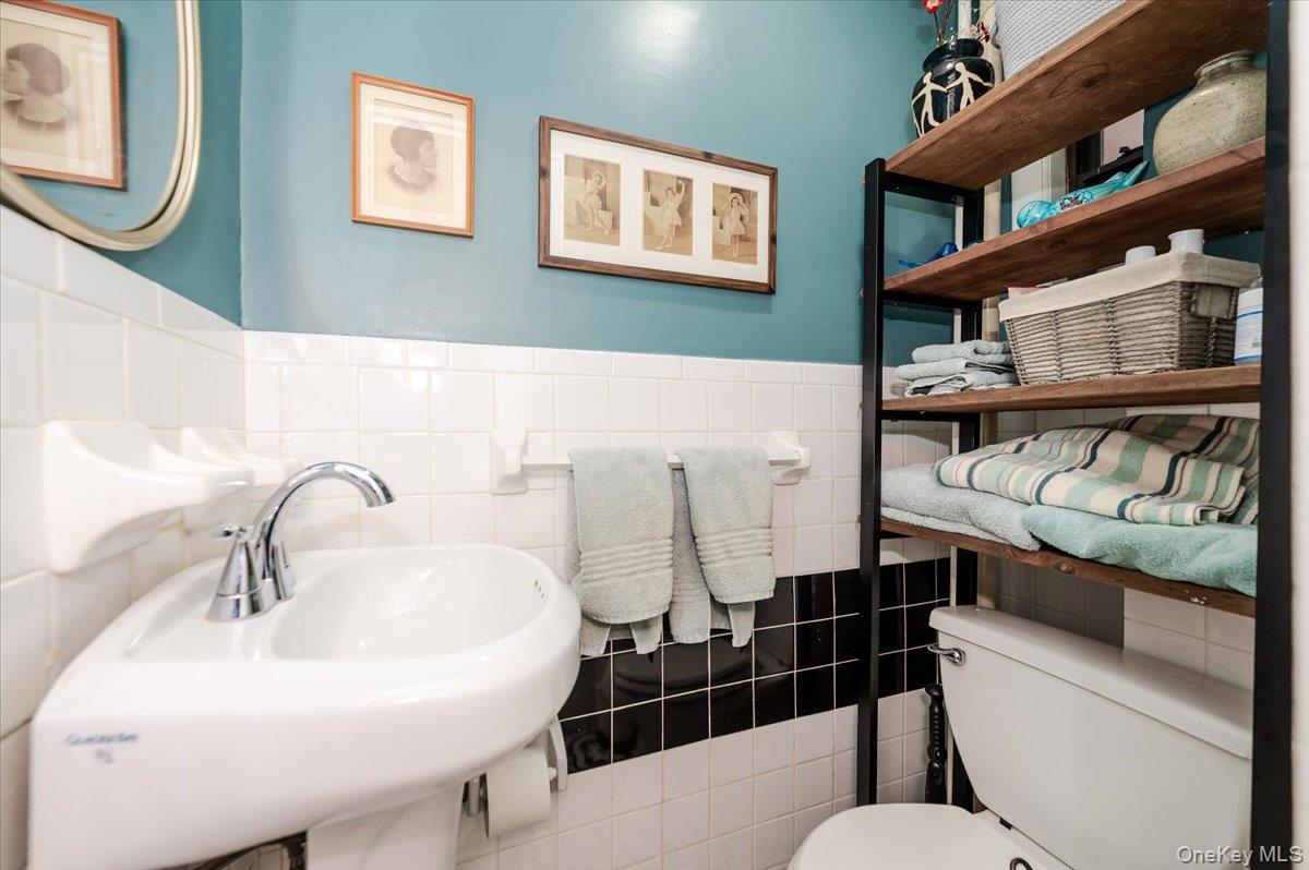 83-00 Talbot Street, Unit 2B Queens, NY 11415 - Photo 13 of 16 a bathroom with a sink and a mirror