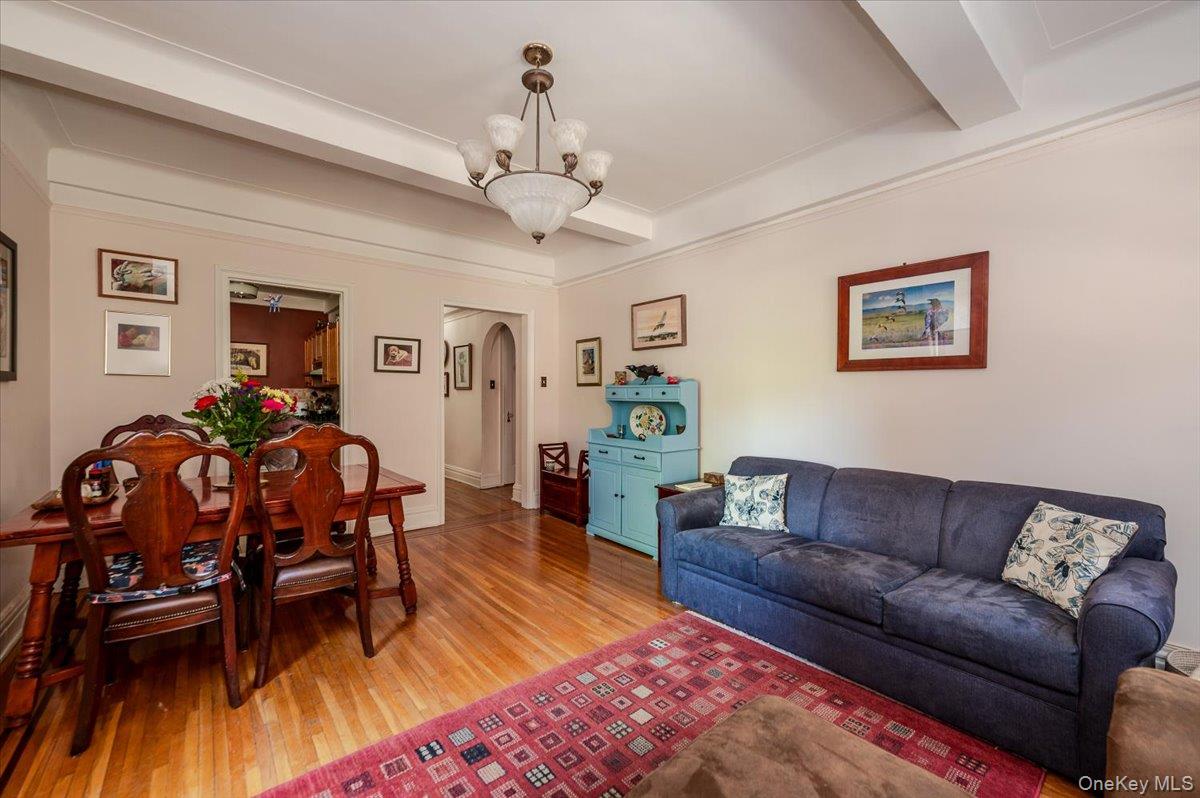 83-00 Talbot Street, Unit 2B Queens, NY 11415 - Photo 7 of 16 a living room with furniture and wooden floor