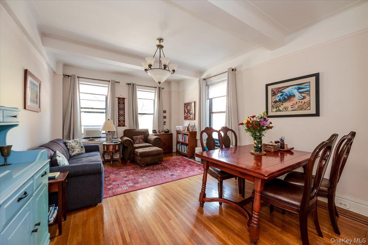 83-00 Talbot Street, Unit 2B Queens, NY 11415 - Photo 8 of 16 a view of a dining room with furniture window and wooden floor