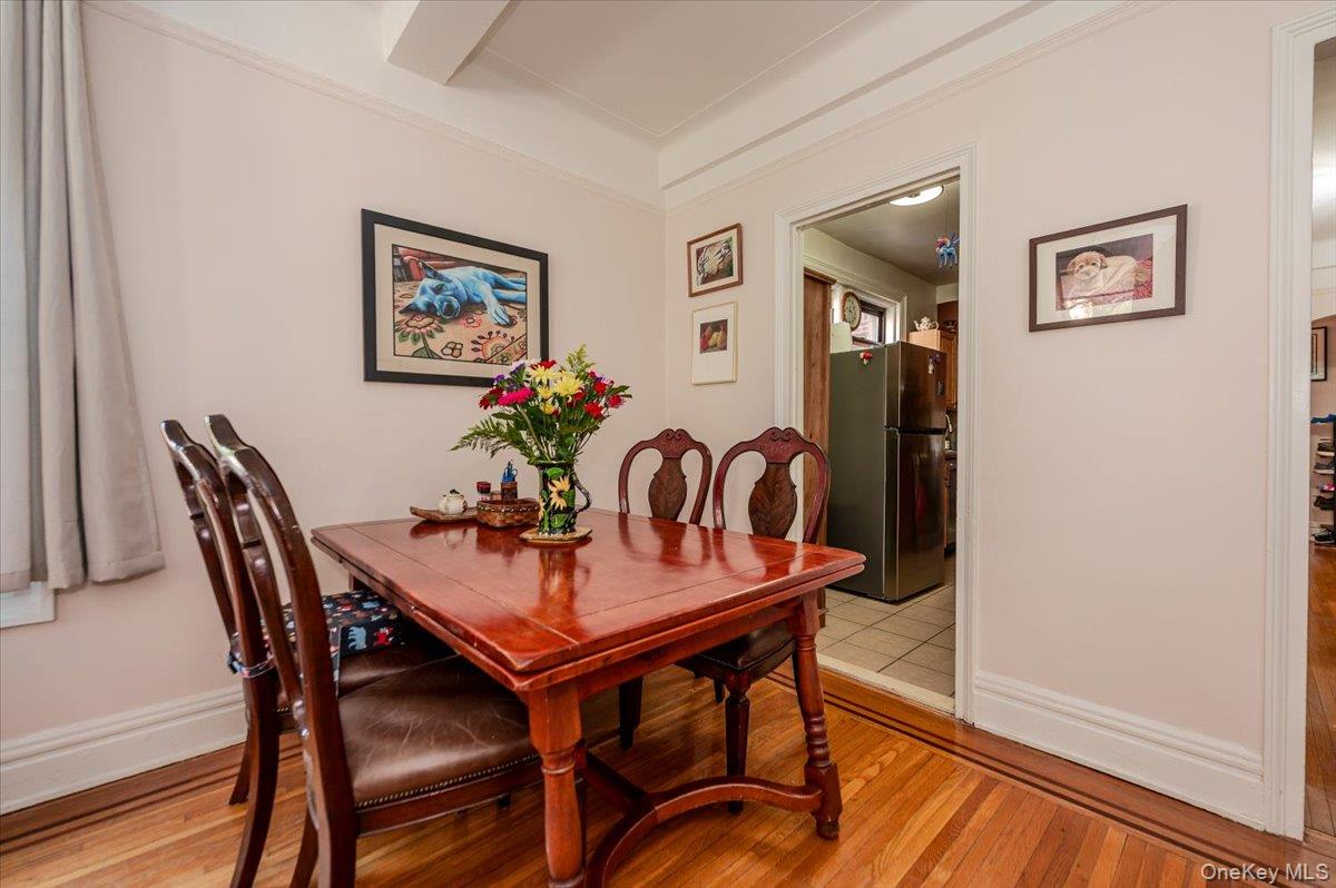 83-00 Talbot Street, Unit 2B Queens, NY 11415 - Photo 9 of 16 a view of a dining room with furniture and wooden floor