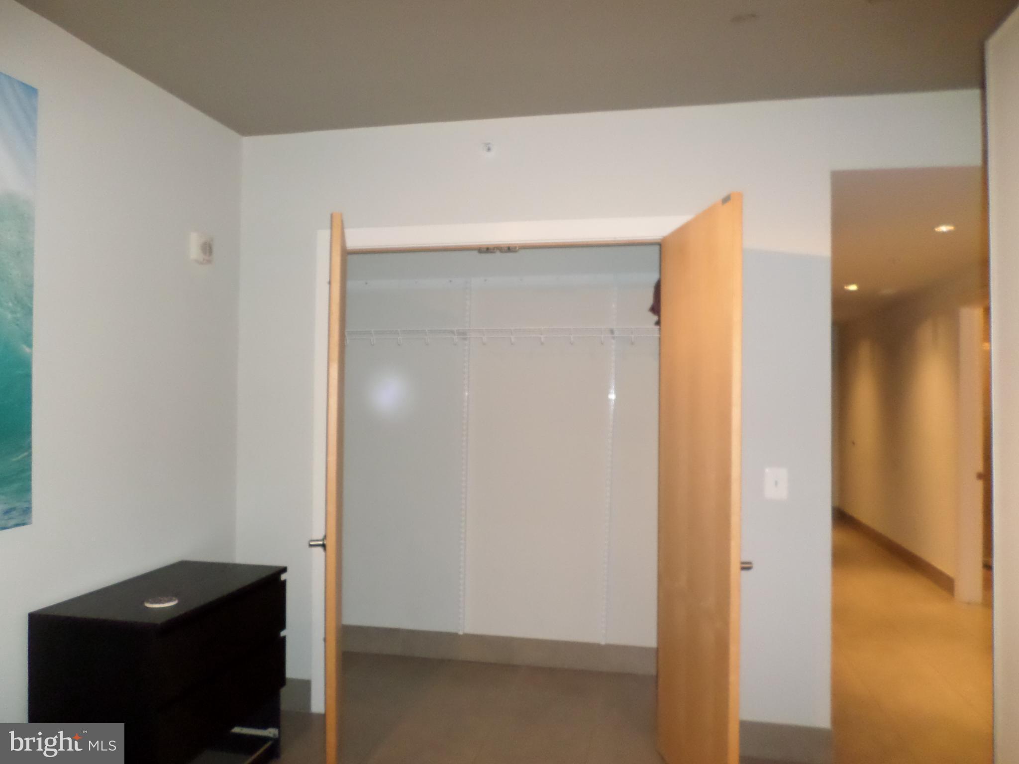 1133 14th Street Northwest, Unit 903 Washington, DC 20005 - Photo 6 of 18 Bedroom closet & hallway to bathroom