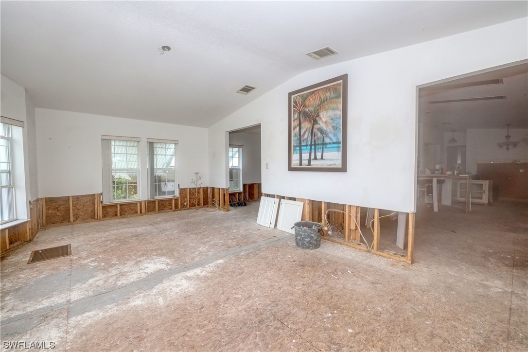 149 Raintree Lane Fort Myers, FL 33908 - Photo 12 of 22 a spacious bedroom with a bed a couch and large window
