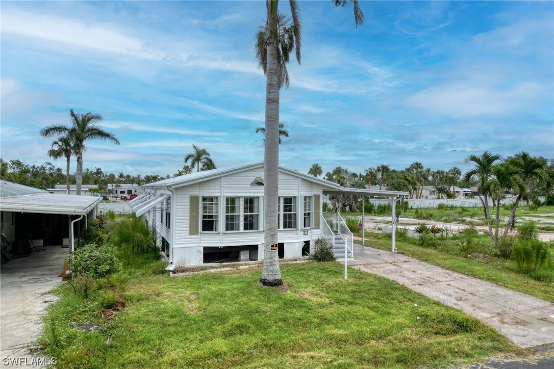 149 Raintree Lane Fort Myers, FL 33908 - Photo 2 of 22 a front view of a house with a yard