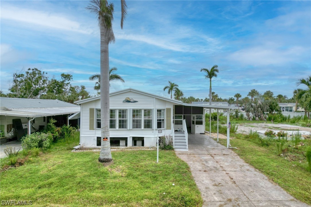 149 Raintree Lane Fort Myers, FL 33908 - Photo 3 of 22 a front view of a house with a yard
