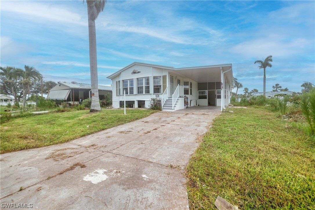 149 Raintree Lane Fort Myers, FL 33908 - Photo 9 of 22 a view of a house with a big yard and potted plants