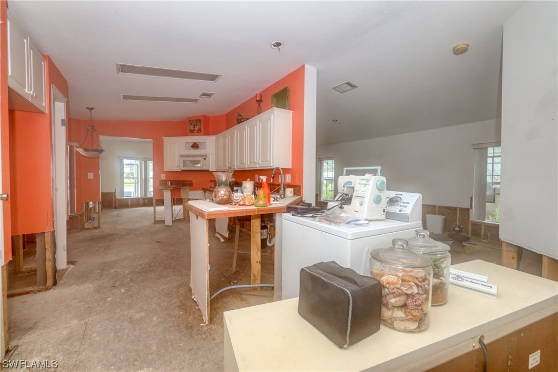 149 Raintree Lane Fort Myers, FL 33908 - Photo 10 of 22 a room with fireplace a washer and dryer