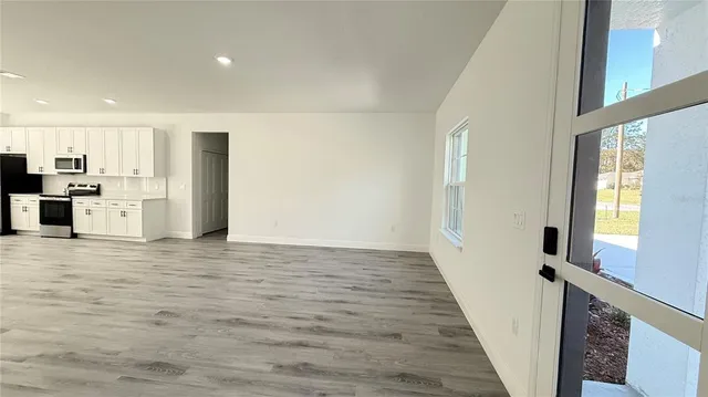 a view of a kitchen with a sink and a refrigerator