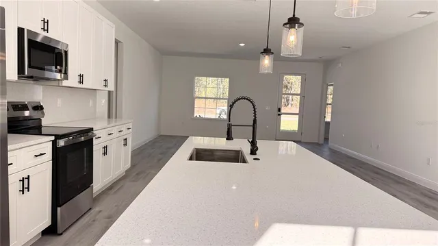 a kitchen with a sink cabinets and window