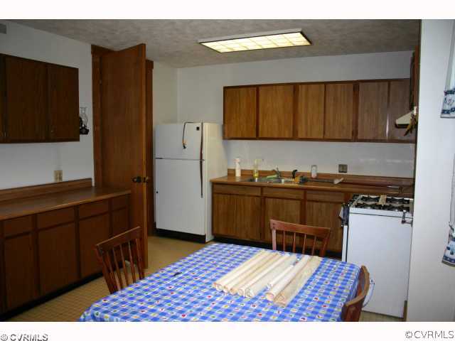 3620 Shepherd Spring Road Gum Spring, VA 23065 - Photo 4 of 8 a kitchen with a refrigerator and a stove top oven