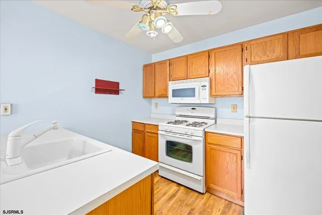 a kitchen with a sink a stove and refrigerator
