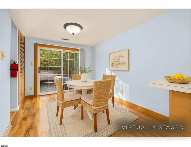 a view of a dining room with furniture and a window