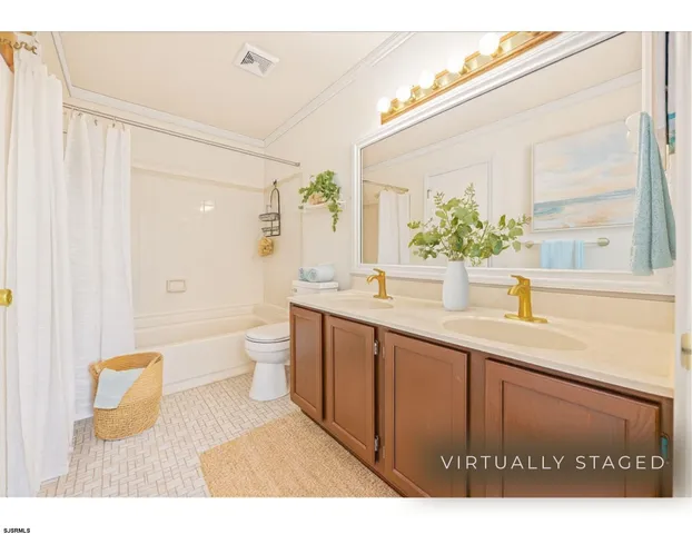 a bathroom with a granite countertop sink a toilet and shower