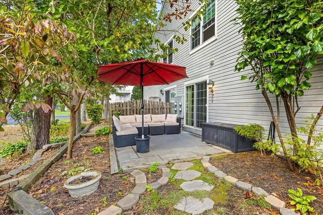 a view of a patio with table and chairs under an umbrella