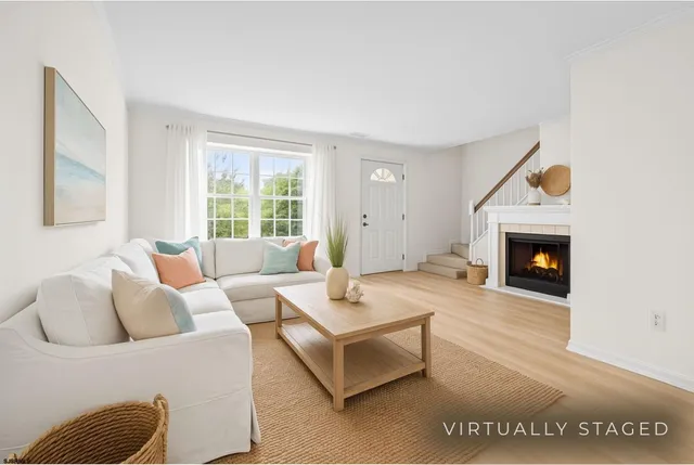a living room with furniture a window and a fireplace