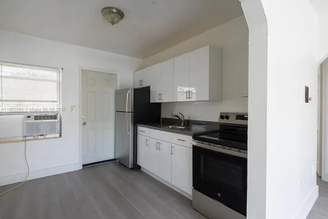 a kitchen with a stove and a refrigerator