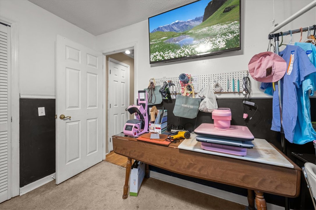 668 Marcengill Road Westminster, SC 29693 - Photo 23 of 37 A versatile interior space featuring a dedicated workspace with ample storage and overhead illumination.