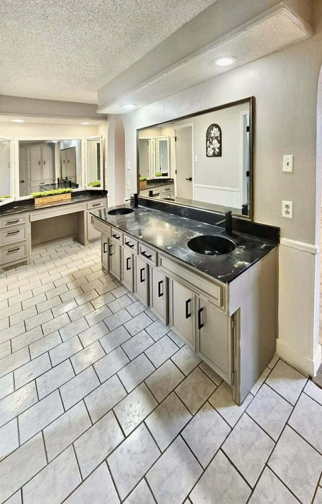 3710 75th Street Lubbock, TX 79423 - Photo 12 of 36 a kitchen with stainless steel appliances granite countertop a stove and cabinets