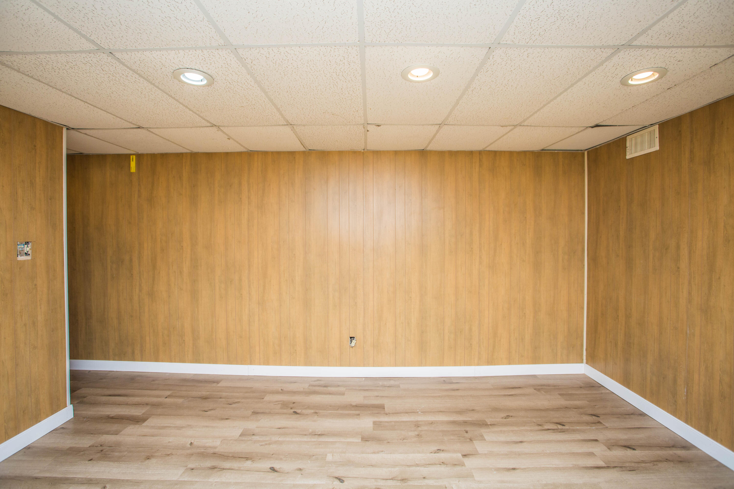 3710 75th Street Lubbock, TX 79423 - Photo 20 of 36 an empty room with wooden floor and fan