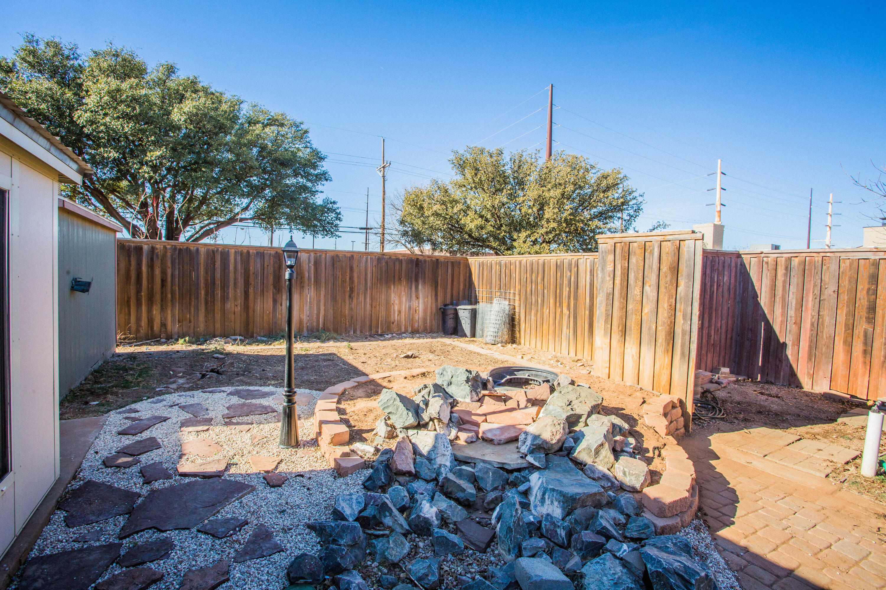 3710 75th Street Lubbock, TX 79423 - Photo 29 of 36 a backyard of a house with table and chairs