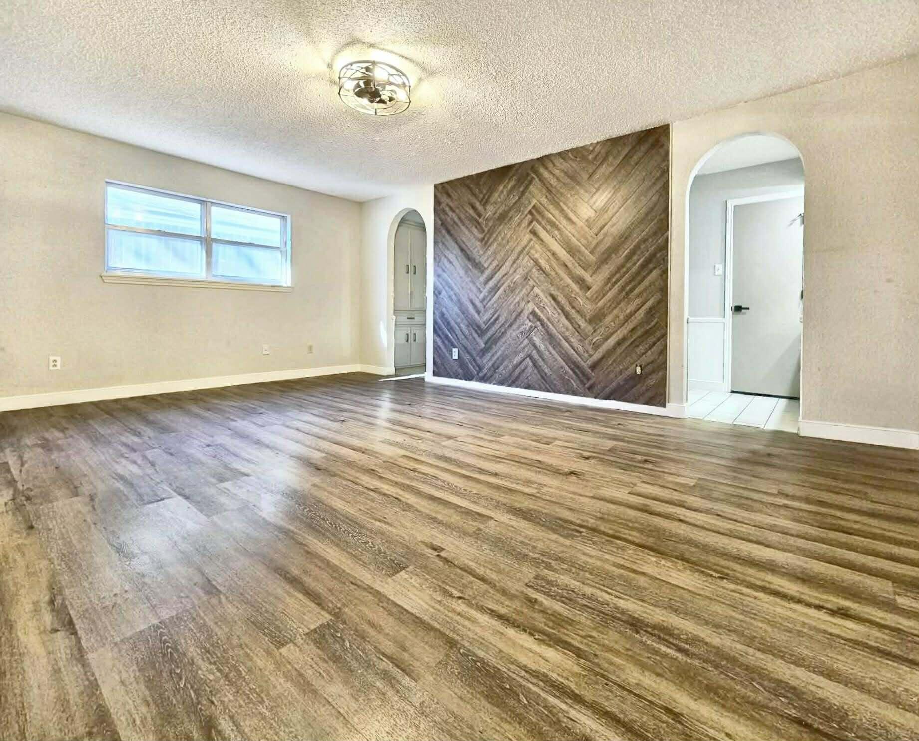 3710 75th Street Lubbock, TX 79423 - Photo 10 of 36 an empty room with wooden floor and windows