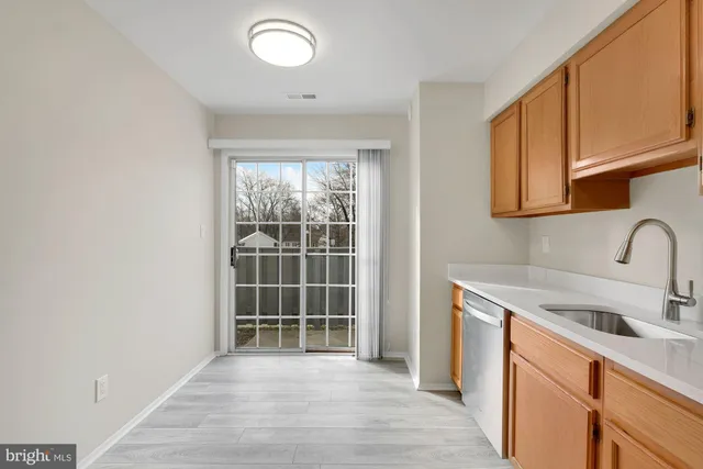 a kitchen with a sink cabinets and a window