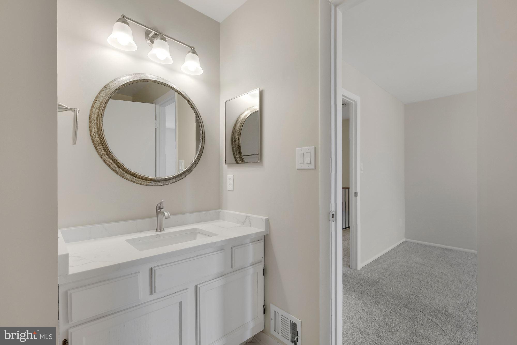3030 Piano Lane, Unit 56 Silver Spring, MD 20904 - Photo 16 of 28 a bathroom with a sink and a mirror