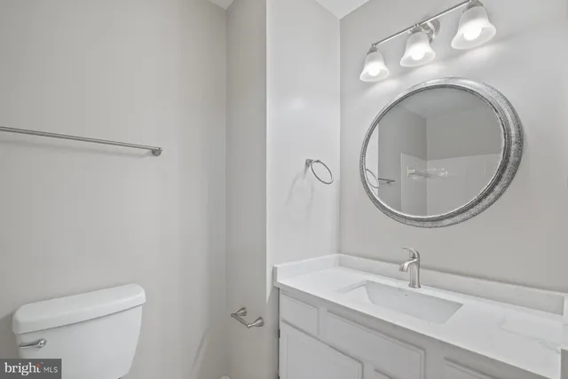 a bathroom with a toilet a sink and a mirror