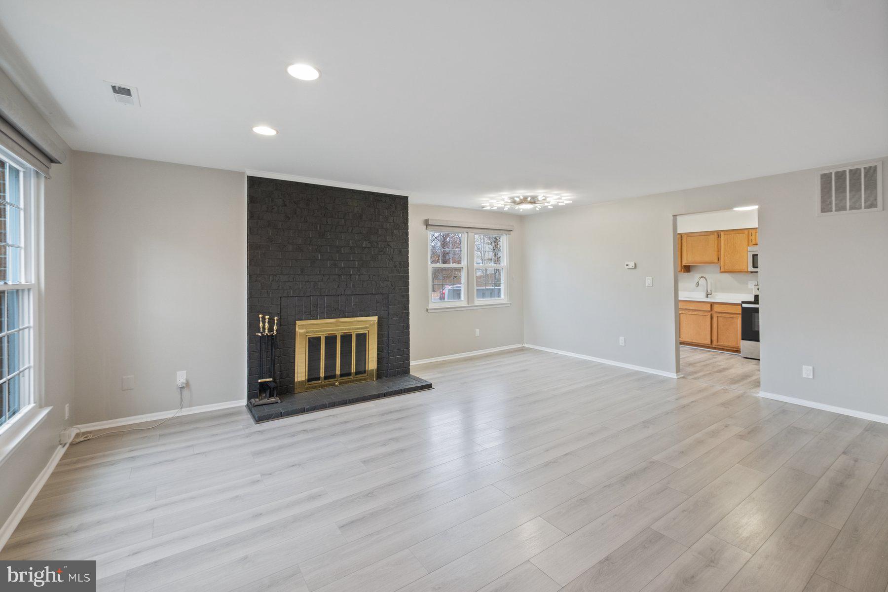 3030 Piano Lane, Unit 56 Silver Spring, MD 20904 - Photo 4 of 28 a view of an empty room with wooden floor and a window