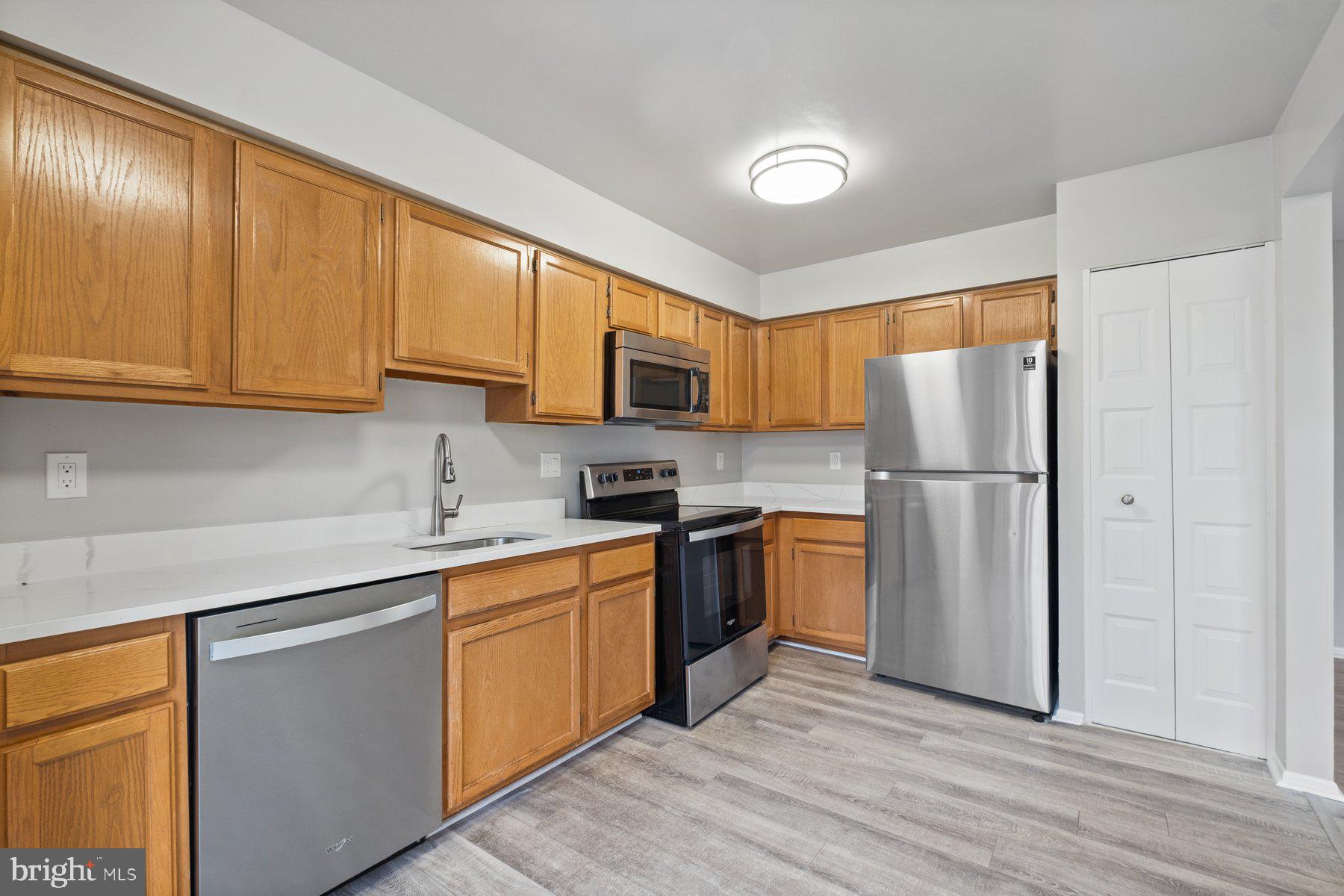 3030 Piano Lane, Unit 56 Silver Spring, MD 20904 - Photo 9 of 28 a kitchen with a refrigerator sink and microwave