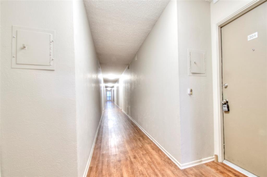 4837 Cedar Springs Road, Unit 304 Dallas, TX 75219 - Photo 14 of 32 a view of a hallway with wooden floor