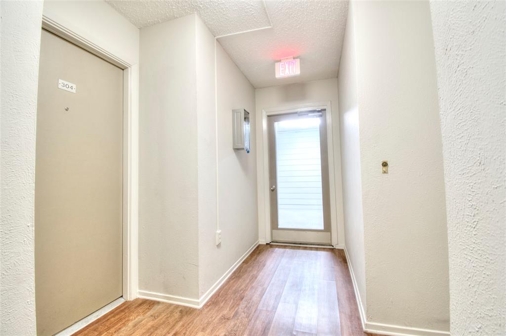 4837 Cedar Springs Road, Unit 304 Dallas, TX 75219 - Photo 15 of 32 a view of a hallway with wooden floor