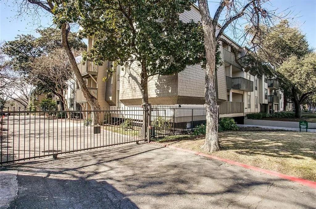 4837 Cedar Springs Road, Unit 304 Dallas, TX 75219 - Photo 27 of 32 a view of a house with large trees and a small yard