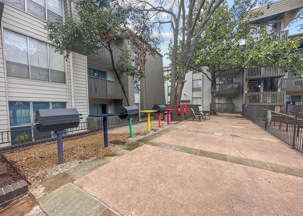 4837 Cedar Springs Road, Unit 304 Dallas, TX 75219 - Photo 28 of 32 a sign board with a bench in the patio