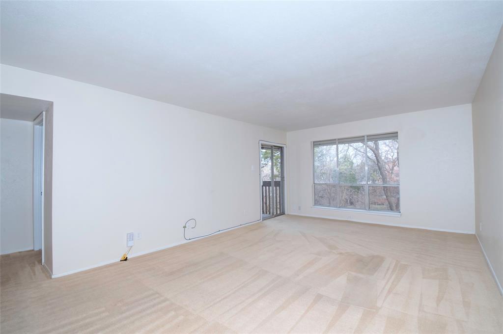 4837 Cedar Springs Road, Unit 304 Dallas, TX 75219 - Photo 5 of 32 a view of an empty room with a window