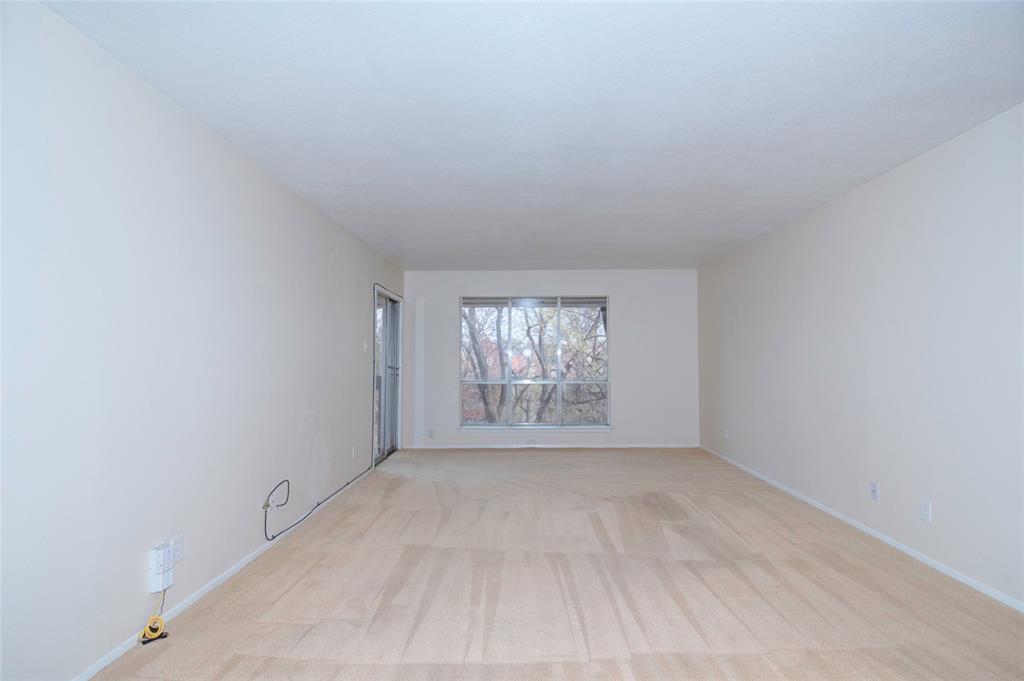 4837 Cedar Springs Road, Unit 304 Dallas, TX 75219 - Photo 9 of 32 wooden floor in an empty room with a window