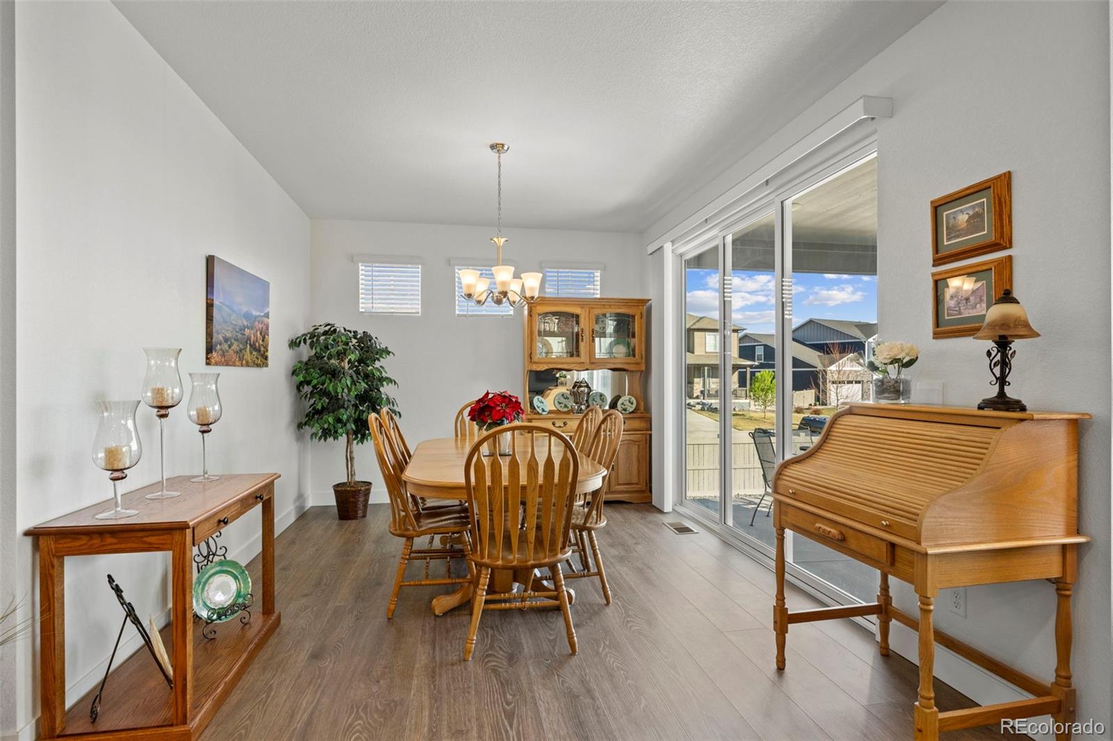 1680 Rivergate Way Berthoud, CO 80513 - Photo 12 of 41 a dining room filled chandelier and wooden floor