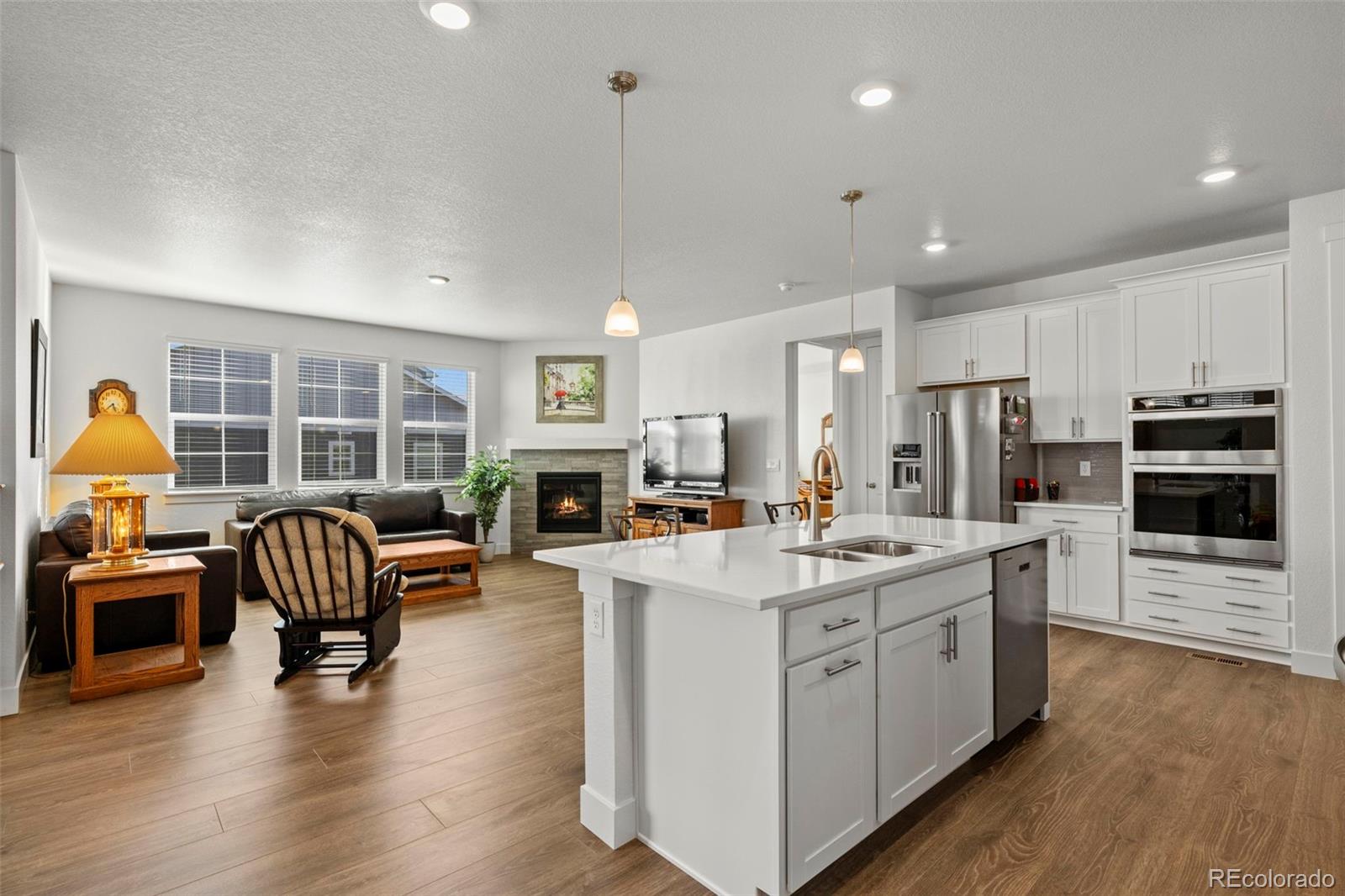 1680 Rivergate Way Berthoud, CO 80513 - Photo 14 of 41 a kitchen with stainless steel appliances granite countertop a stove a sink a oven a dining table and chairs