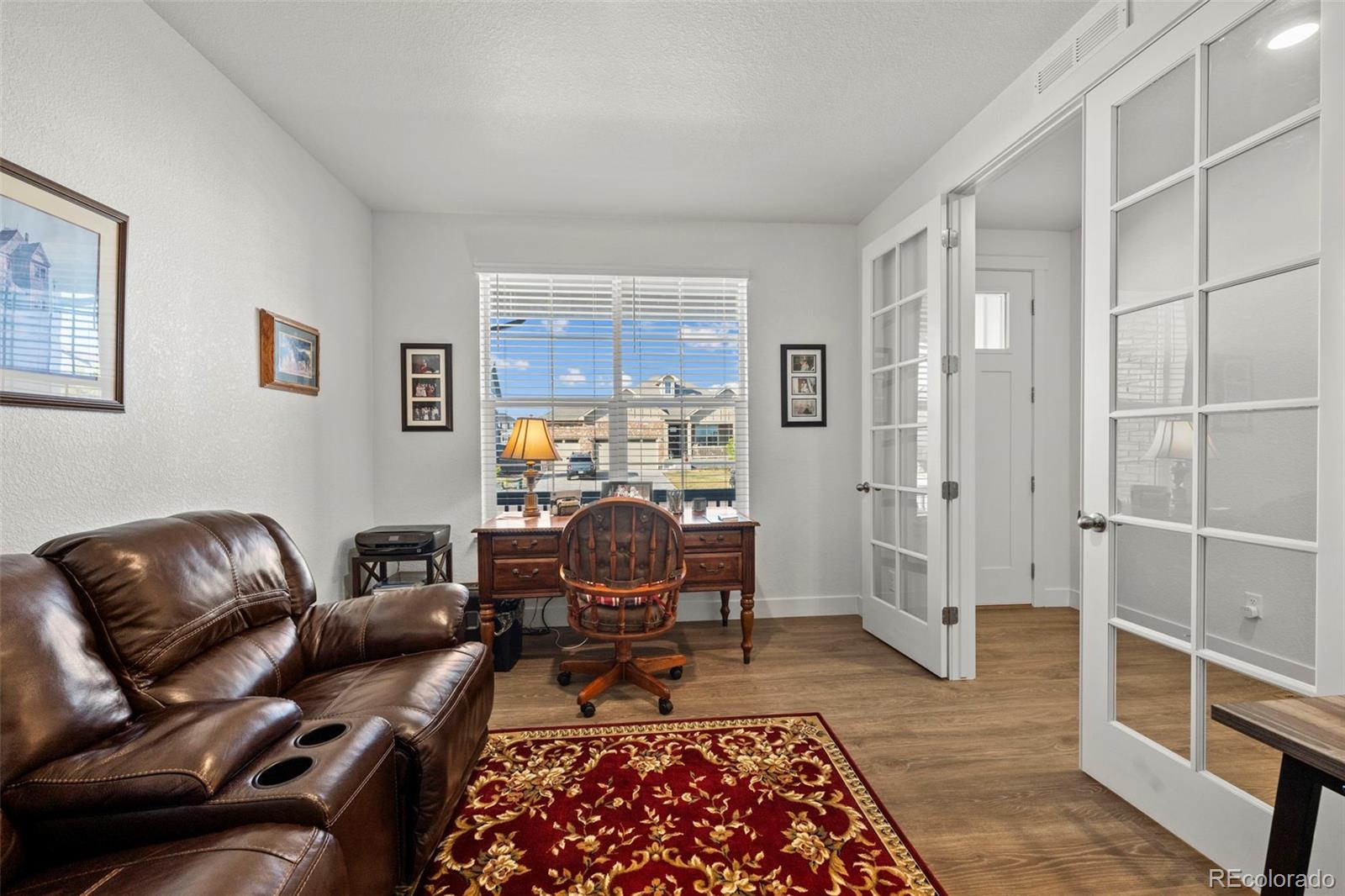 1680 Rivergate Way Berthoud, CO 80513 - Photo 4 of 41 a living room with furniture or couch and a rug
