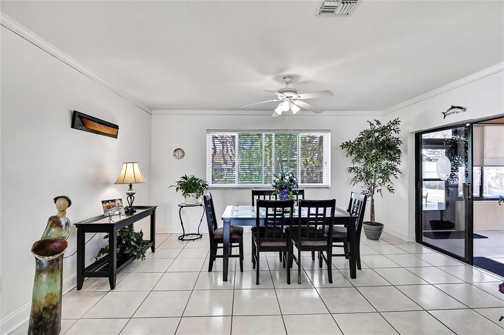 9059 Gaynor Street Spring Hill, FL 34608 - Photo 11 of 36 a view of a dining room with furniture and chandelier