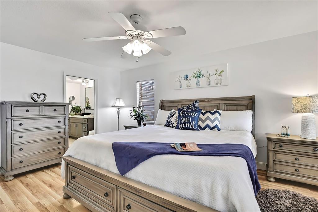 9059 Gaynor Street Spring Hill, FL 34608 - Photo 18 of 36 a bedroom with a bed and a chandelier