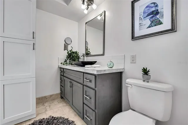 a spacious bedroom with a bed and a dresser