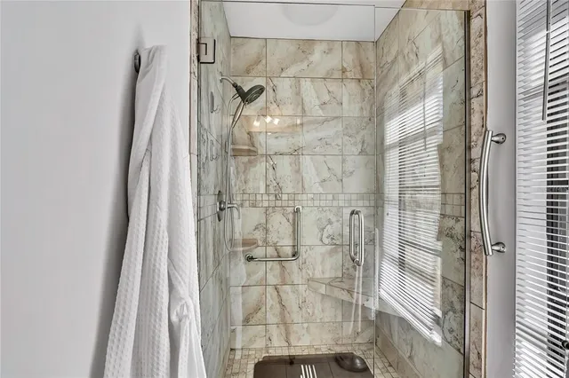 a bathroom with a granite countertop sink a toilet and mirror