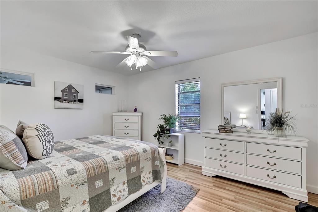 9059 Gaynor Street Spring Hill, FL 34608 - Photo 25 of 36 a spacious bedroom with a bed and a dresser