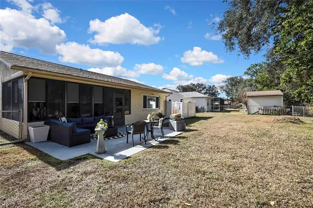 a living room with furniture and potted plants